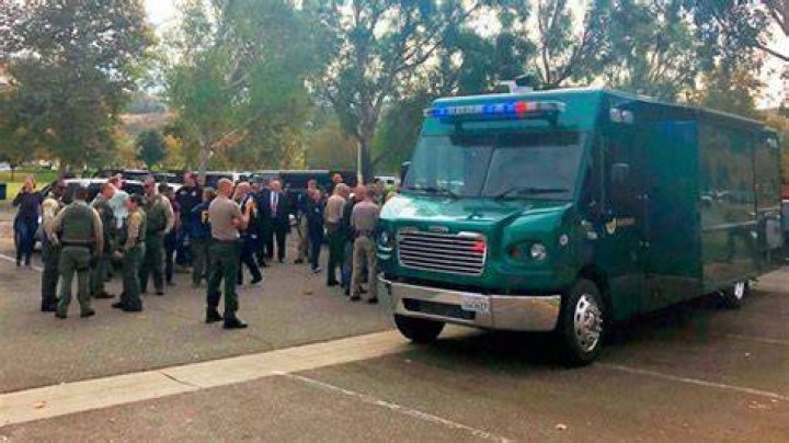 Policed Gathered In Front Of A Squad Car After California High School Shooting