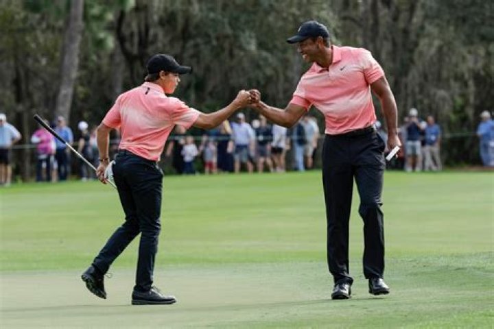Tiger Woods, right and his son Charlie Woods, right, bump fists during the first round of the PNC Championship golf tournament, in Orlando, Fla PNC Championship Golf, Orlando, United States - 17 Dec 2022